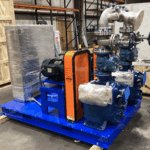 GR T4 duplex pump skid system with stainless steel piping, control panel, and Uniguard vertical belt and chain guard